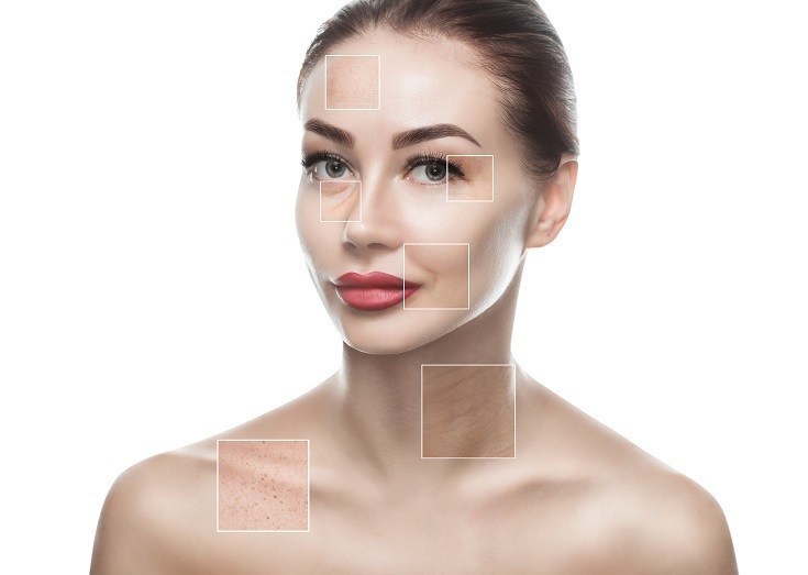 Portrait of a beautiful woman on a white background, on the face are visible areas of problem skin - wrinkles and freckles. Cosmetology concept.